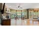 Bright living room with stone fireplace, hardwood floors, and oversized windows overlooking the backyard at 104 Kremer Falls Trce, Canton, GA 30114