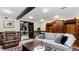Comfortable living room featuring built-in shelving, a large sofa, and an adjacent dining area at 104 Kremer Falls Trce, Canton, GA 30114