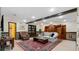 A beautifully decorated living room boasts a grey sofa, leather armchair, wainscoting and wooden ceiling beams at 104 Kremer Falls Trce, Canton, GA 30114