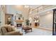 Inviting living room with a stone fireplace, hardwood floors, and large windows for plenty of natural light at 104 Kremer Falls Trce, Canton, GA 30114