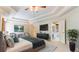 Luxurious main bedroom featuring a sitting area, tray ceilings, and ample natural light at 104 Kremer Falls Trce, Canton, GA 30114
