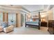 Bright and airy main bedroom featuring a four-poster bed, sitting area, and large windows at 104 Kremer Falls Trce, Canton, GA 30114