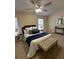 Bedroom with a ceiling fan, a bench in front of the bed, and two windows at 2991 Greyhawk Ln, Cumming, GA 30040