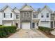 Charming townhome featuring a stone accent, garage, and well-maintained landscaping at 2991 Greyhawk Ln, Cumming, GA 30040