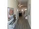 Hallway with neutral paint, gray flooring, and decorative accents leading to living spaces at 2991 Greyhawk Ln, Cumming, GA 30040