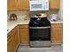Kitchen with stainless appliances, laminate floors and wood cabinets at 2991 Greyhawk Ln, Cumming, GA 30040