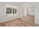 Bright living room featuring wood-look floors and large windows with views of the outdoors at 3261 Lions Ruby Ln, Atlanta, GA 30349
