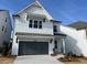 Charming two-story home features white siding, a gray garage door, and a well-manicured front yard at 629 Skytop Dr, Cumming, GA 30040