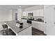 Modern kitchen featuring an island, granite countertops, stainless steel appliances, and white cabinetry at 7771 Sudbury Cir, Covington, GA 30014