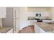 Well-lit kitchen with stainless steel appliances, granite countertops, and ample cabinet space at 7771 Sudbury Cir, Covington, GA 30014