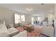 Spacious living room with comfortable seating, modern decor, and seamlessly integrates with kitchen and dining area at 7771 Sudbury Cir, Covington, GA 30014