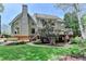 Expansive backyard with a deck, lush lawn, mature trees, and meticulously landscaped garden beds at 9770 Rod Rd, Alpharetta, GA 30022