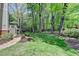 Lush backyard with garden area and a stone path at 9770 Rod Rd, Alpharetta, GA 30022
