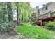 Expansive backyard featuring a well-manicured lawn and a deck with an umbrella at 9770 Rod Rd, Alpharetta, GA 30022