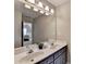 Bathroom with a large, framed mirror, dual sinks, and neutral-toned vanity at 9770 Rod Rd, Alpharetta, GA 30022