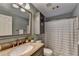 Clean bathroom featuring a granite vanity, shower with curtain, and modern fixtures at 9770 Rod Rd, Alpharetta, GA 30022