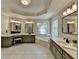 Luxurious bathroom with a large soaking tub, dual vanities, and decorative leaded glass window at 9770 Rod Rd, Alpharetta, GA 30022