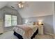 Cozy bedroom featuring a ceiling fan, plush carpeting, and a brightly lit window at 9770 Rod Rd, Alpharetta, GA 30022