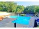 Relax by the pool, surrounded by mature trees and ample seating, a feature of this community at 9770 Rod Rd, Alpharetta, GA 30022