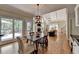 Dining area with cathedral ceiling, hardwood floors, and view of the living room at 9770 Rod Rd, Alpharetta, GA 30022