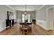 Formal dining room with hardwood floors, wainscoting, chandelier, and ample seating at 9770 Rod Rd, Alpharetta, GA 30022