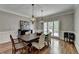 Elegant dining room with hardwood floors, chandelier, and stylish decor at 9770 Rod Rd, Alpharetta, GA 30022