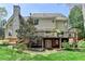Back of house with deck, patio and manicured lawn at 9770 Rod Rd, Alpharetta, GA 30022