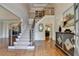 Grand foyer featuring hardwood floors, staircase with iron spindles, and elegant chandelier at 9770 Rod Rd, Alpharetta, GA 30022