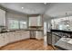 Gourmet kitchen with white cabinets, granite countertops, stainless steel appliances, and hardwood floors at 9770 Rod Rd, Alpharetta, GA 30022