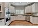 Well-appointed kitchen featuring custom cabinetry, modern appliances, and stylish backsplash at 9770 Rod Rd, Alpharetta, GA 30022