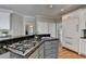 This kitchen has an island cooktop, granite countertops, and modern appliances that create a chef-inspired space at 9770 Rod Rd, Alpharetta, GA 30022