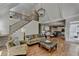 Open concept living area featuring a fireplace, hardwood floors, and views to kitchen and staircase at 9770 Rod Rd, Alpharetta, GA 30022