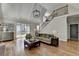 Comfortable living room with large windows, vaulted ceilings, a fireplace, and hardwood floors at 9770 Rod Rd, Alpharetta, GA 30022