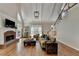 The sun-filled living room features a brick fireplace, vaulted ceilings, and a staircase with iron railings at 9770 Rod Rd, Alpharetta, GA 30022