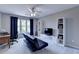 Relaxing living room with a futon, shelving, and bright window with navy curtains at 9770 Rod Rd, Alpharetta, GA 30022