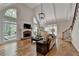 Bright living room featuring high ceilings, large windows, and a cozy fireplace at 9770 Rod Rd, Alpharetta, GA 30022