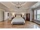 Stylish main bedroom with hardwood floors, decorative ceiling, and natural light at 9770 Rod Rd, Alpharetta, GA 30022