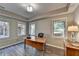 Bright home office with wood floors, a spacious desk, and views of the backyard at 9770 Rod Rd, Alpharetta, GA 30022