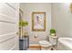 Elegant powder room with painted walls and toilet under framed artwork at 1302 Gardenia Ct, Villa Rica, GA 30180