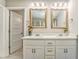 Bright bathroom featuring double vanity, granite countertops, and large framed mirrors for a luxurious feel at 1302 Gardenia Ct, Villa Rica, GA 30180