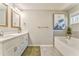 Bathroom with double vanity, large soaking tub, neutral wall color and tile floors at 1302 Gardenia Ct, Villa Rica, GA 30180