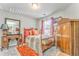 Charming bedroom with vintage furniture, warm accents, and a window offering natural light and peaceful views at 1302 Gardenia Ct, Villa Rica, GA 30180