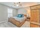 Inviting bedroom with a wooden bed frame, cozy bedding, and a ceiling fan for added comfort at 1302 Gardenia Ct, Villa Rica, GA 30180
