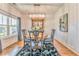 Stylish dining room features a round table, elegant chairs, and lots of natural light at 1302 Gardenia Ct, Villa Rica, GA 30180