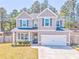 Charming two-story home with a well-manicured lawn, two car garage, and inviting front porch at 1302 Gardenia Ct, Villa Rica, GA 30180