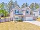 A charming two-story home with a manicured lawn and an attached two-car garage at 1302 Gardenia Ct, Villa Rica, GA 30180