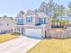 Two-story home featuring a manicured lawn and an attached two-car garage at 1302 Gardenia Ct, Villa Rica, GA 30180