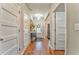 Inviting foyer with hardwood floors, elegant lighting, and stylish decor with multiple doors at 1302 Gardenia Ct, Villa Rica, GA 30180