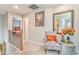 Upstairs hallway with sitting chair and decorative accents at 1302 Gardenia Ct, Villa Rica, GA 30180