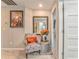 Upstairs hallway with sitting chair and decorative mirror at 1302 Gardenia Ct, Villa Rica, GA 30180